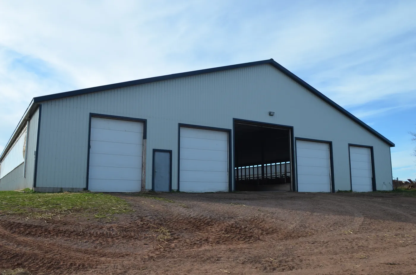 A finished dairy barn with its bay doors open