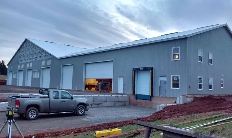 A finished potato storage building with a loading dock, at dusk