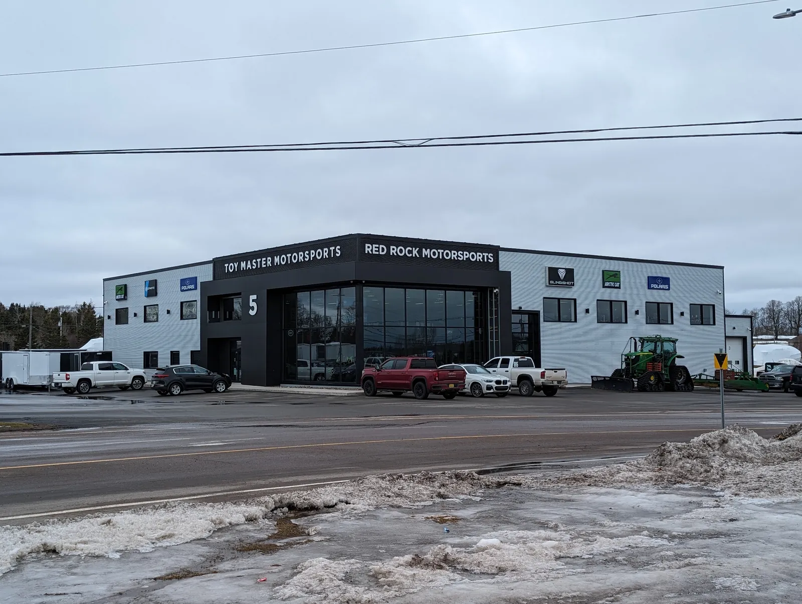 A finished commercial storefront with a covered timber entryway