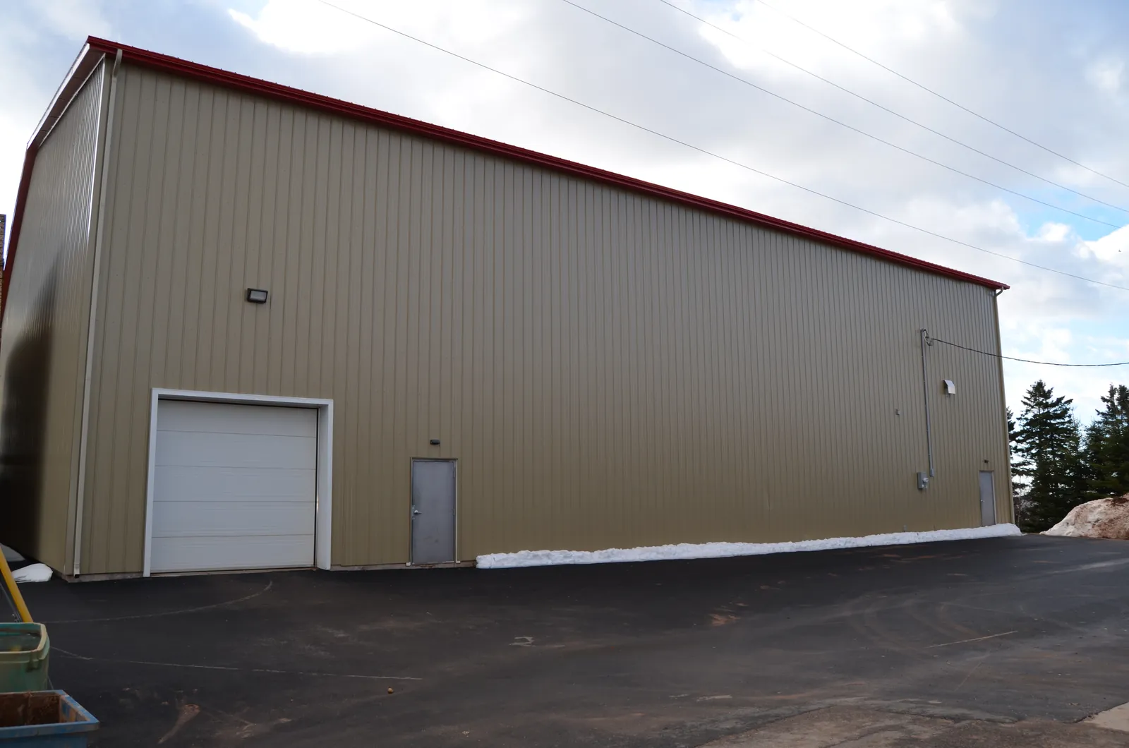 A finished potato storage building with red roof trim